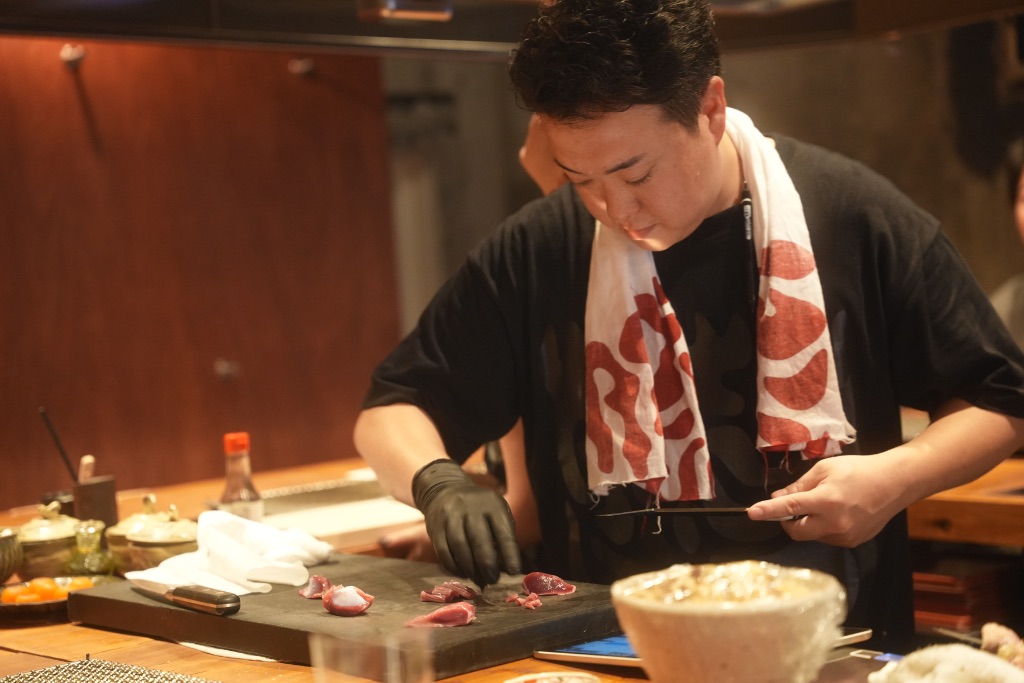 シェフが鶏を丁寧に仕込む